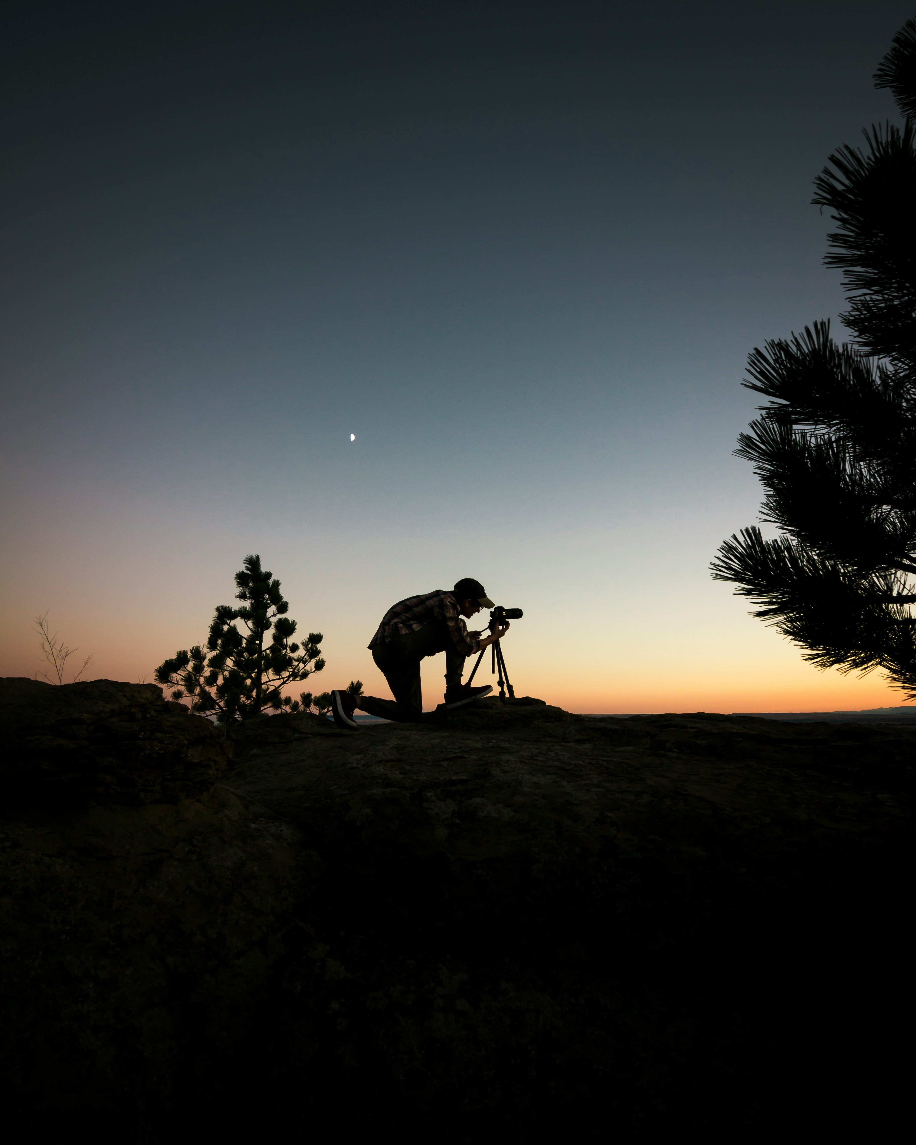 silhouette photography of man capturing photo during night time